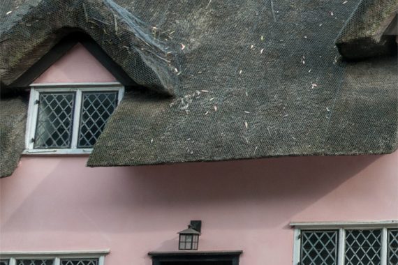 historic-listed-tahtched-home-colour-lime-rendered-pink